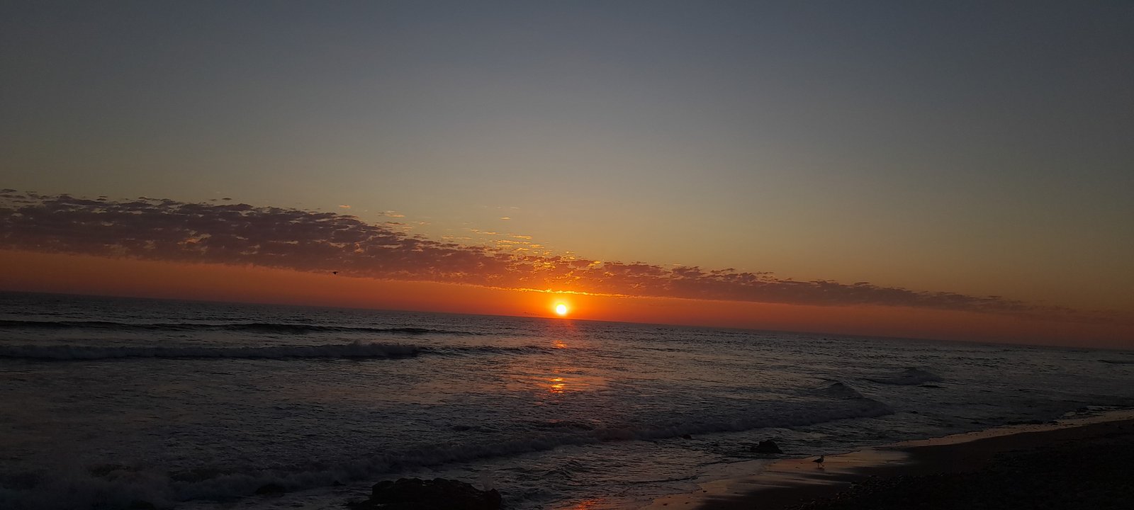 Breathtaking coastal dunes and ocean waves at Sandwich Harbour, Namibia's Ramsar site