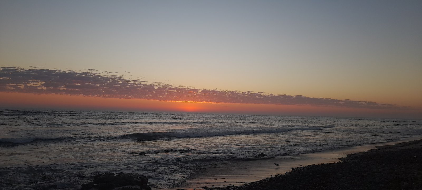 Sunset over the Namib Desert and Atlantic Ocean at Sandwich Harbour, Namibia