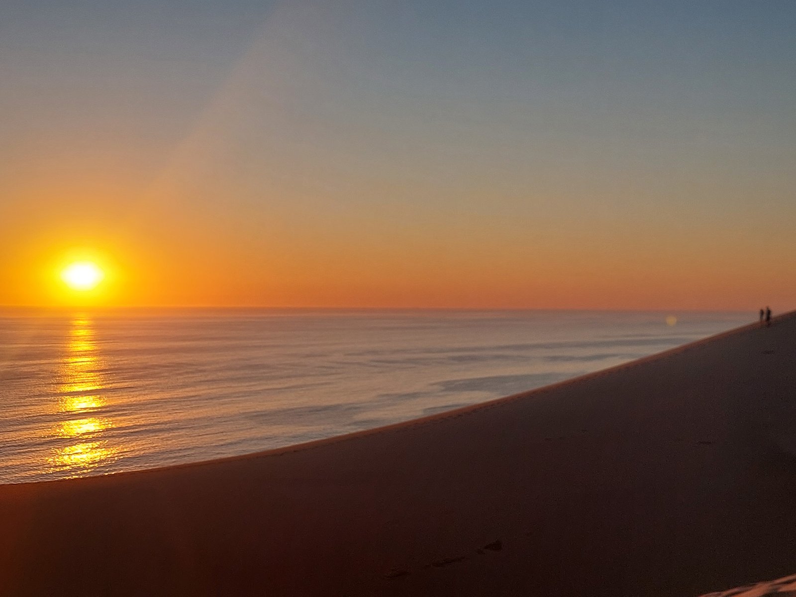 Vast expanse of red sand dunes stretching to the ocean at Sandwich Harbour