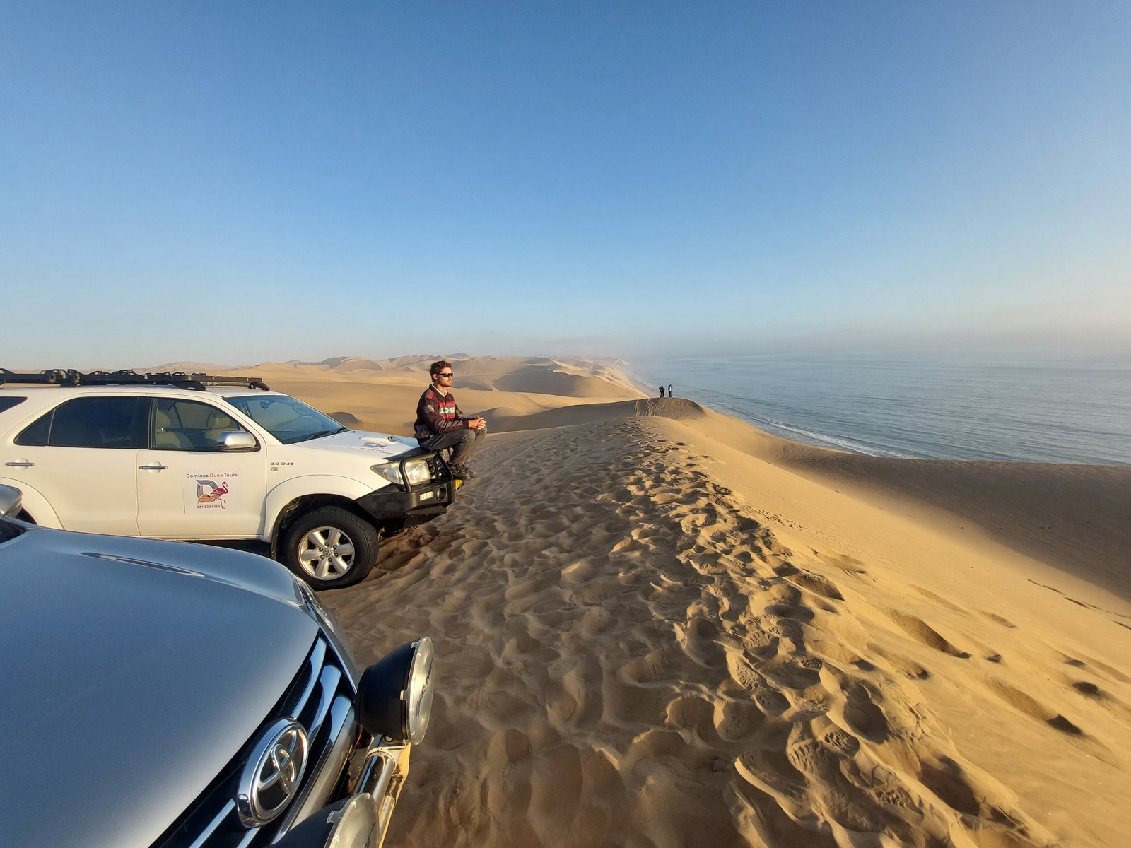 4x4 jeep climbing steep dunes during Sandwich Harbour adventure tour