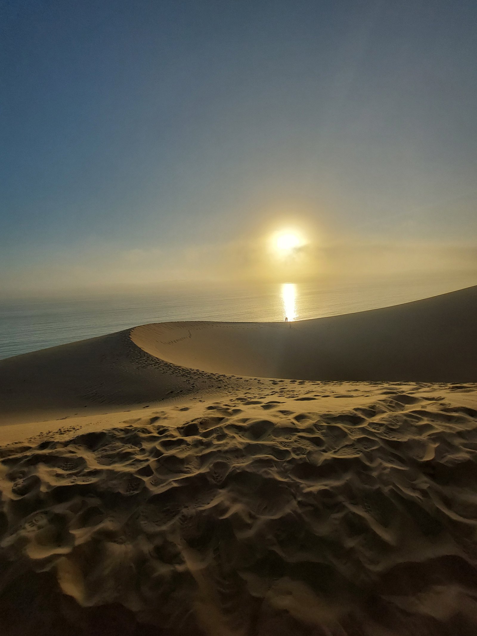 Panoramic view of Sandwich Harbour's unique desert-ocean interface in Namibia